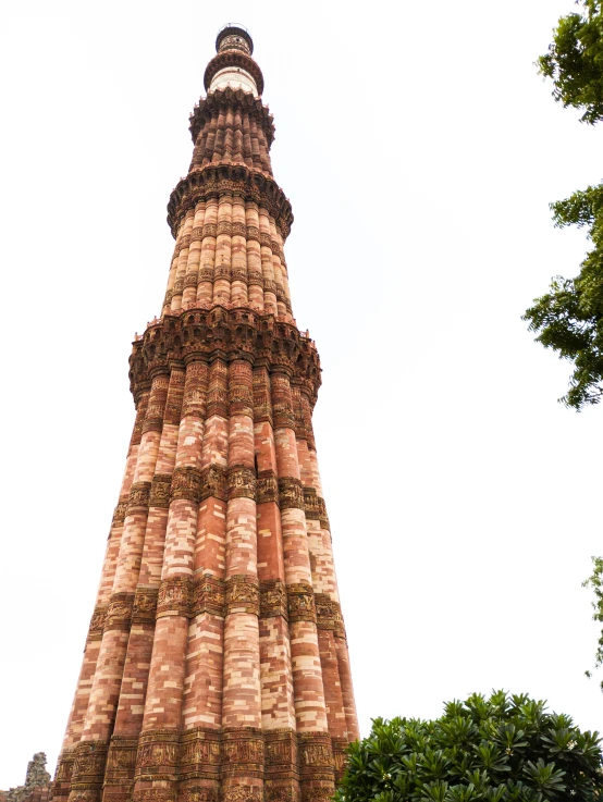 a tall tower that is under a cloudy sky