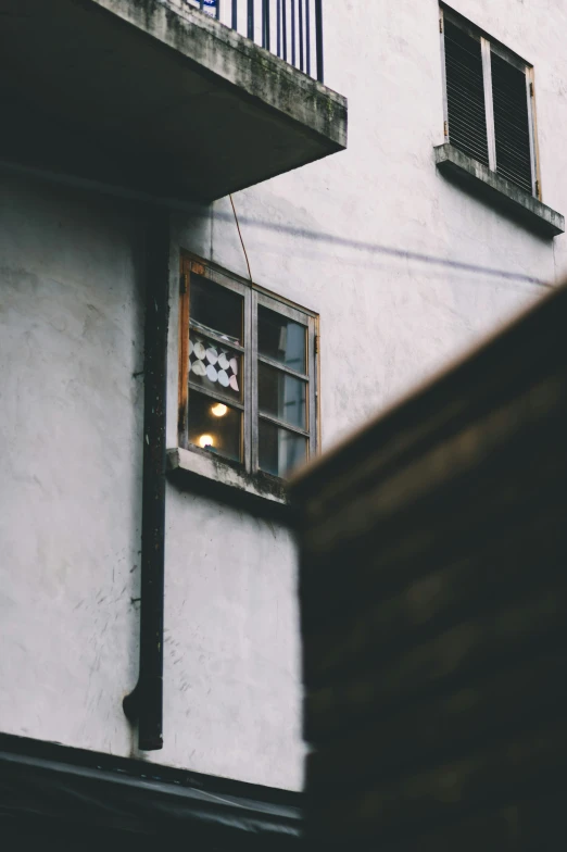 the windows on the side of a building have dim lights