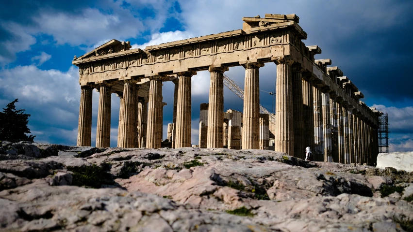 an ancient building sitting on top of a rocky hill