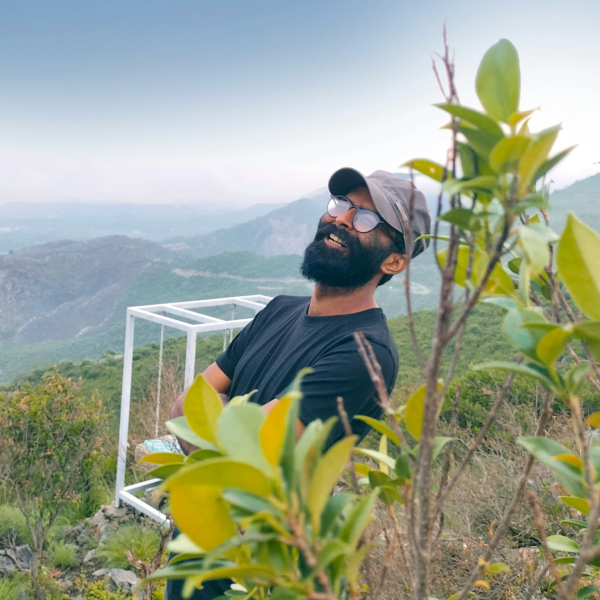 a man with a beard standing in front of a mountain