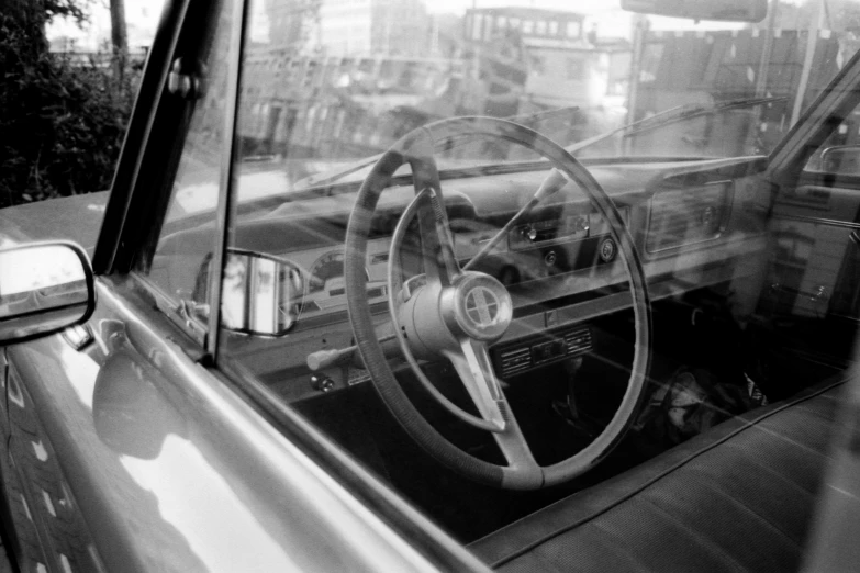 a car sitting in the street with a steering wheel