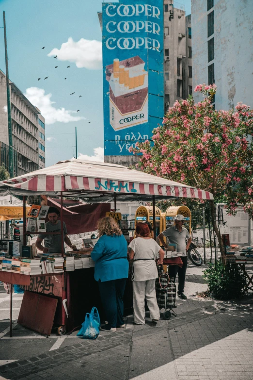 a food stand with a sign and people