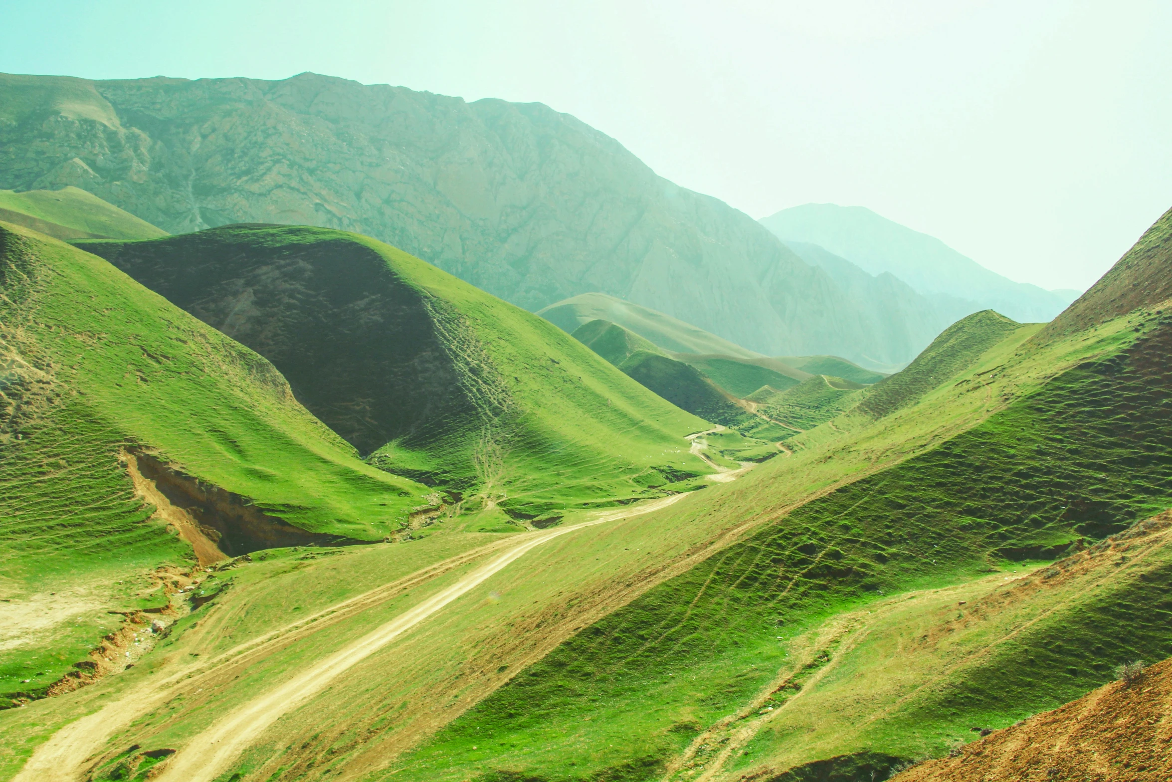 a scenic, mountainous area with green hills