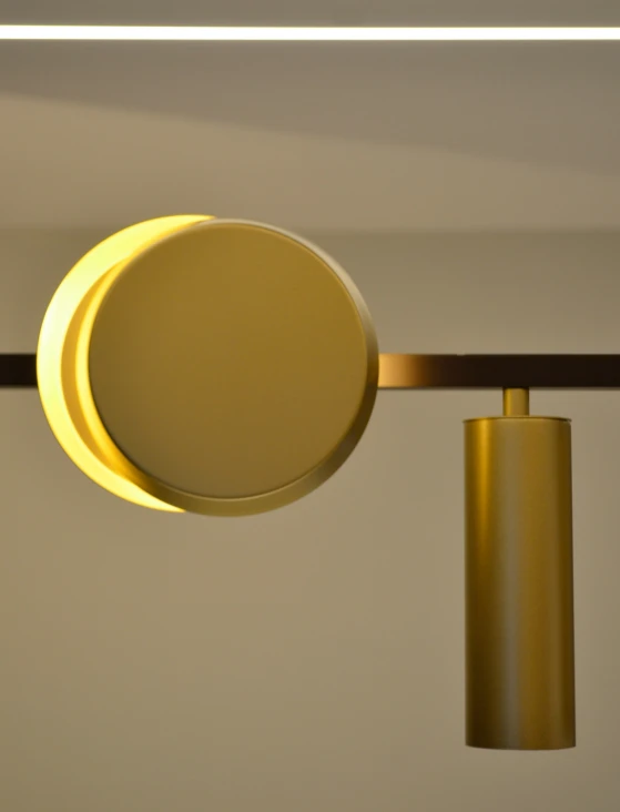 the circular object is illuminated by a light that is on a metal rod