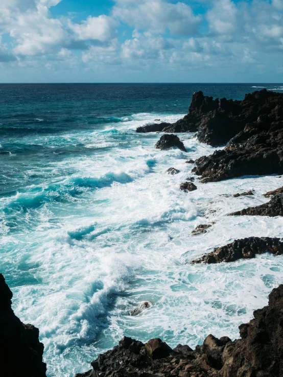 a cliff with very high waves crashing against it