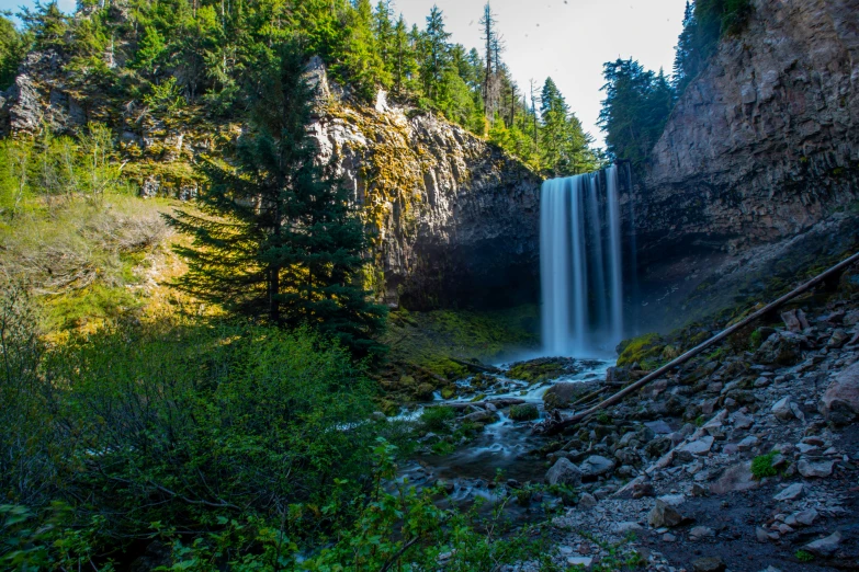 there is a very tall waterfall with trees around it