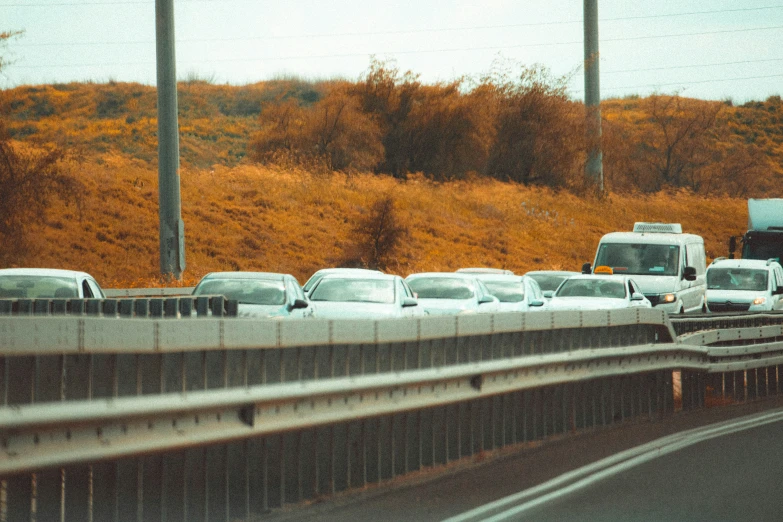 a large group of cars are waiting on the road