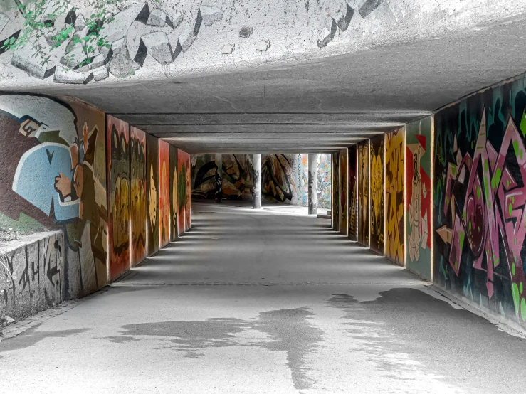 a tunnel with lots of colorful graffiti painted on it