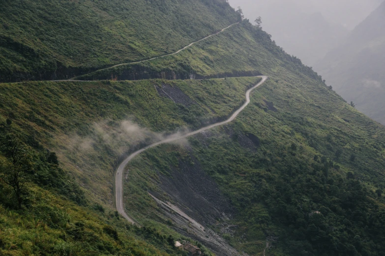 a winding mountain road stretches off into the distance