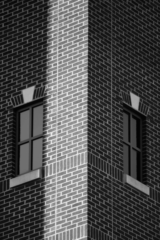 a black and white pograph of a building with two windows