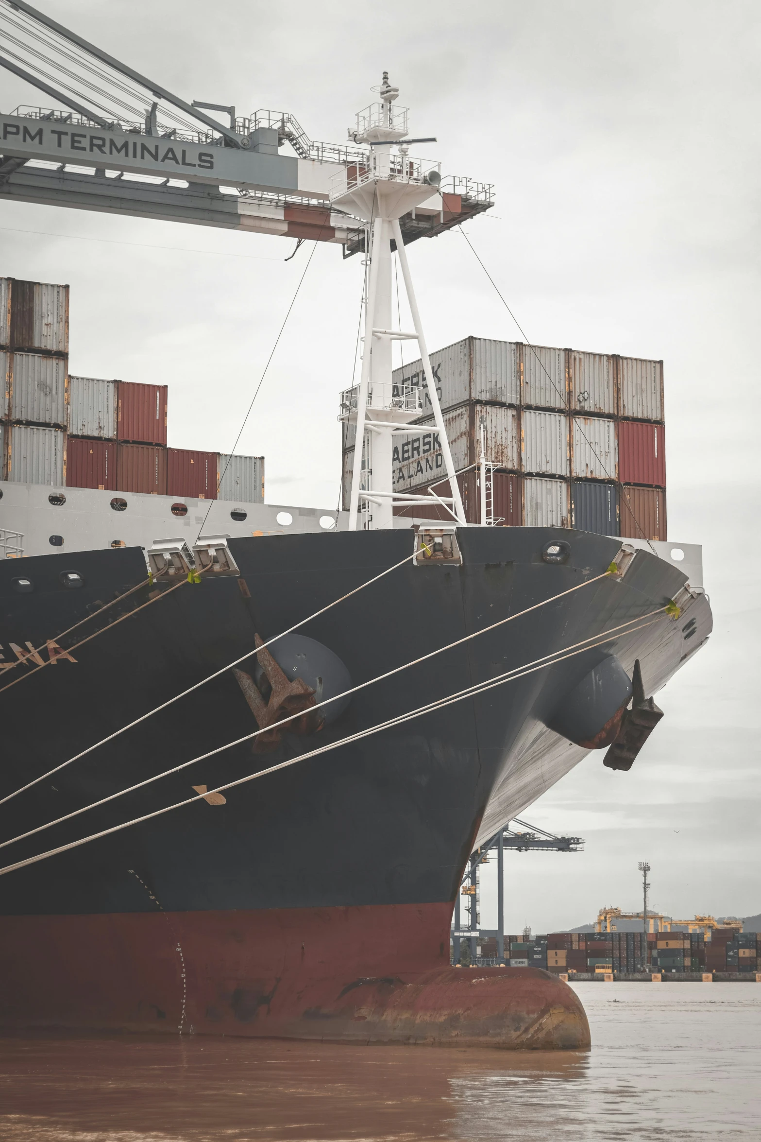 a huge ship with containers on the deck in water