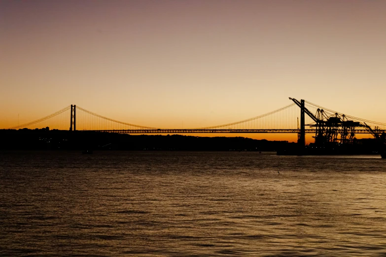 a ship on the water near a bridge