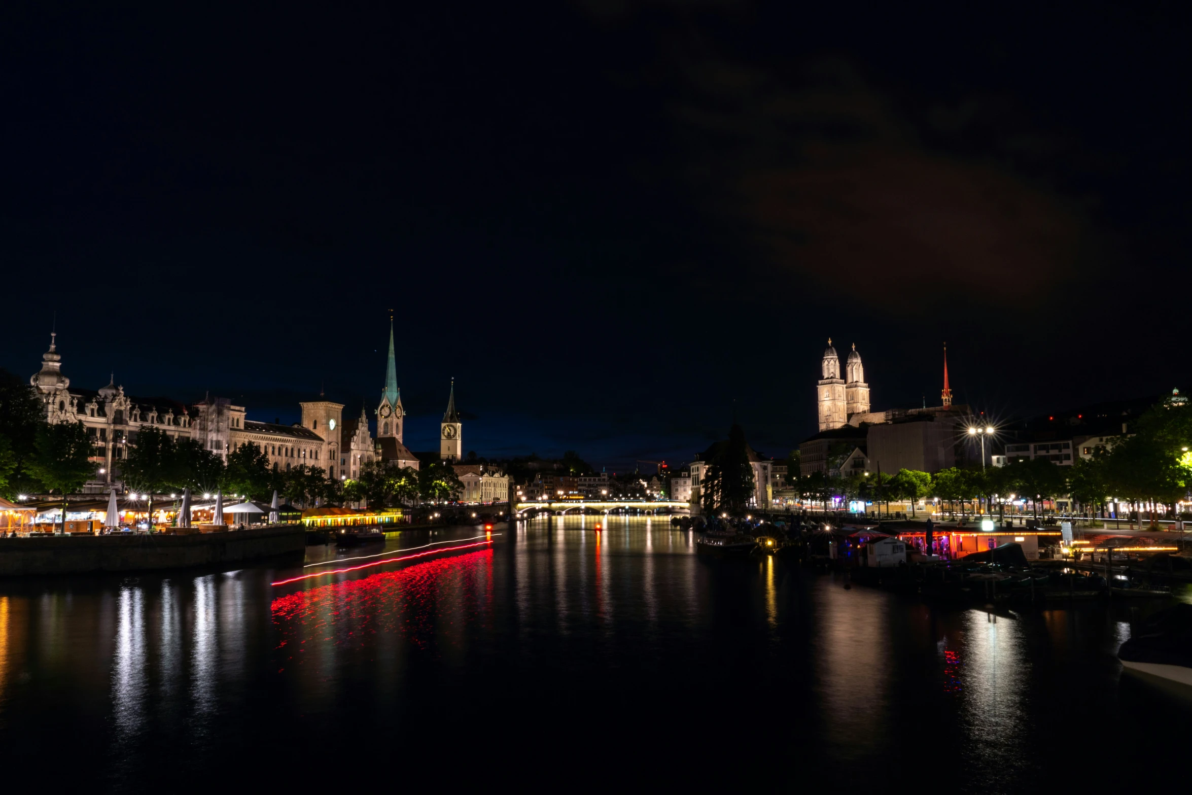 a night view of a city next to a river