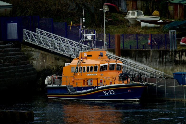 a yellow and blue boat in the water