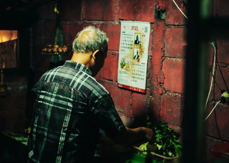 a man prepares food on the counter at his restaurant