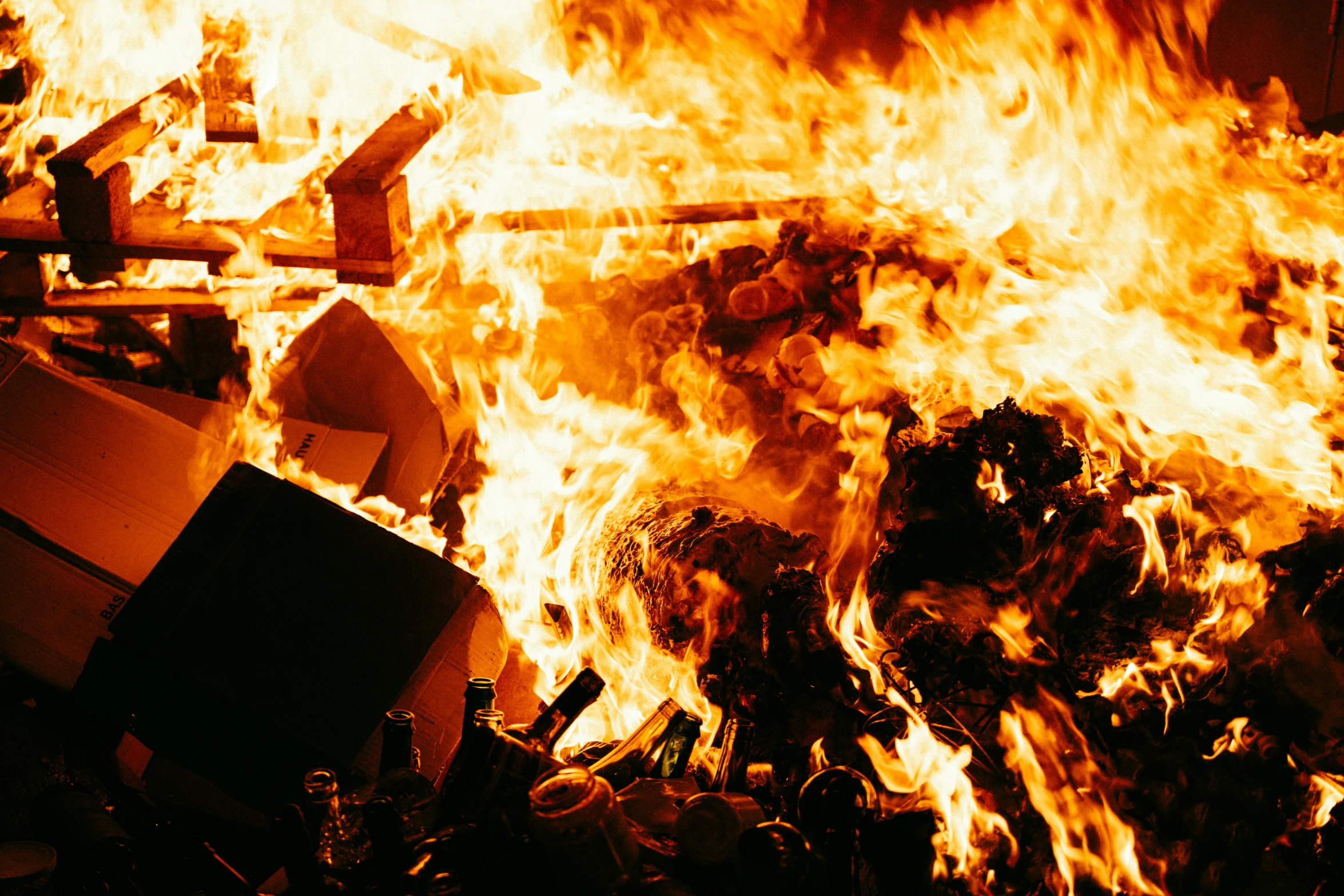 this fire is in an outdoor area and the sky is filled with bright orange flame