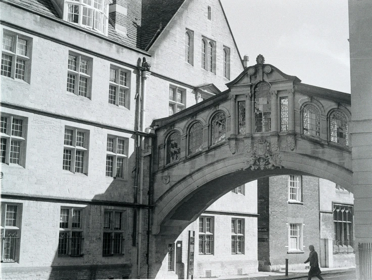 a bridge crossing over water next to tall buildings