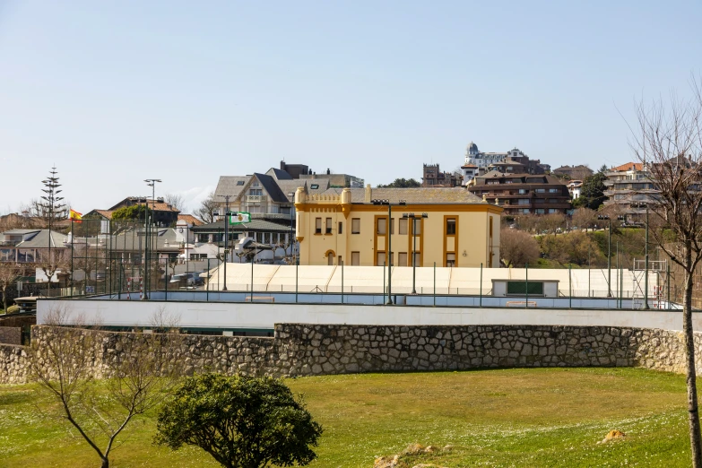 a building on top of a bridge that leads to a park