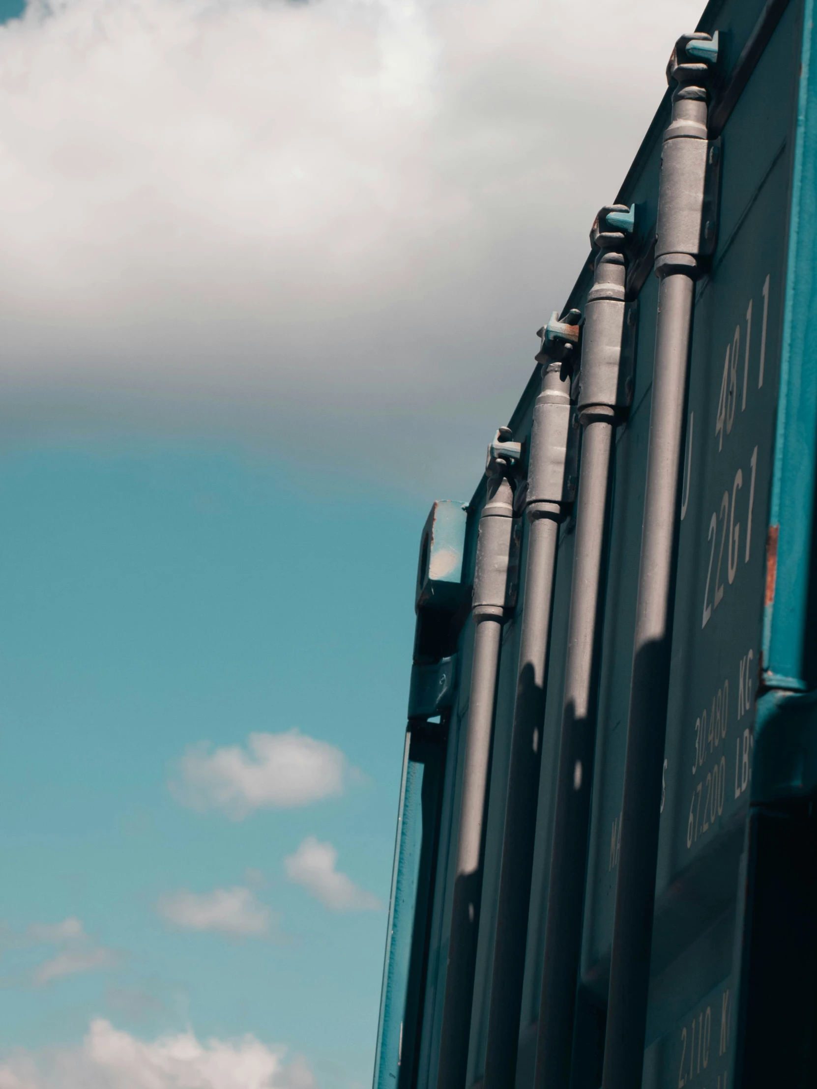 train cars side by side against a blue sky