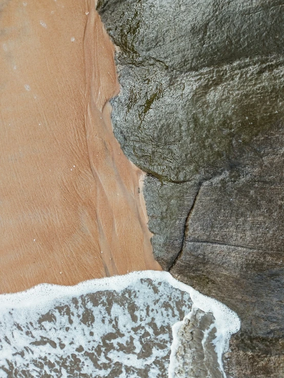 surf splashing on the wet sand at a beach