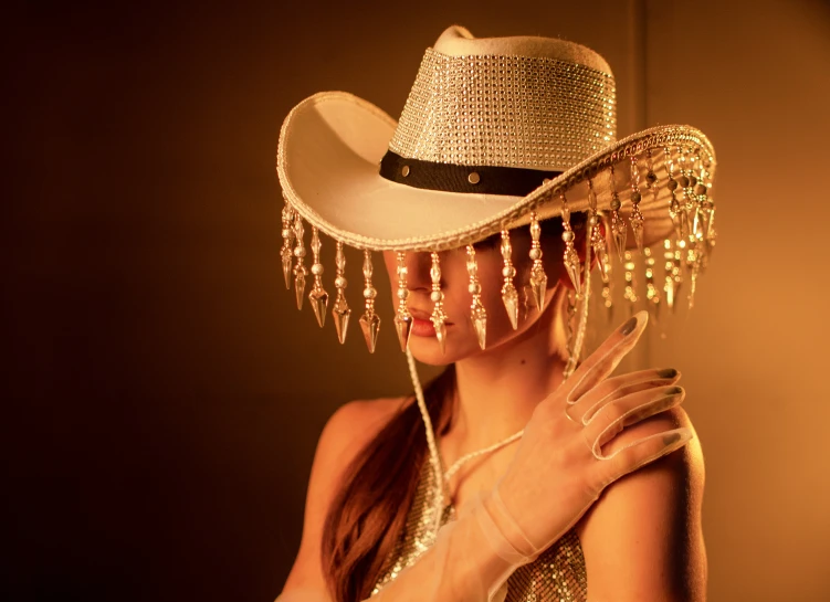 a woman with a hat on posing for a picture