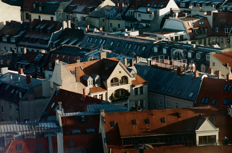 a view of a group of rooftops with a clock tower in the middle