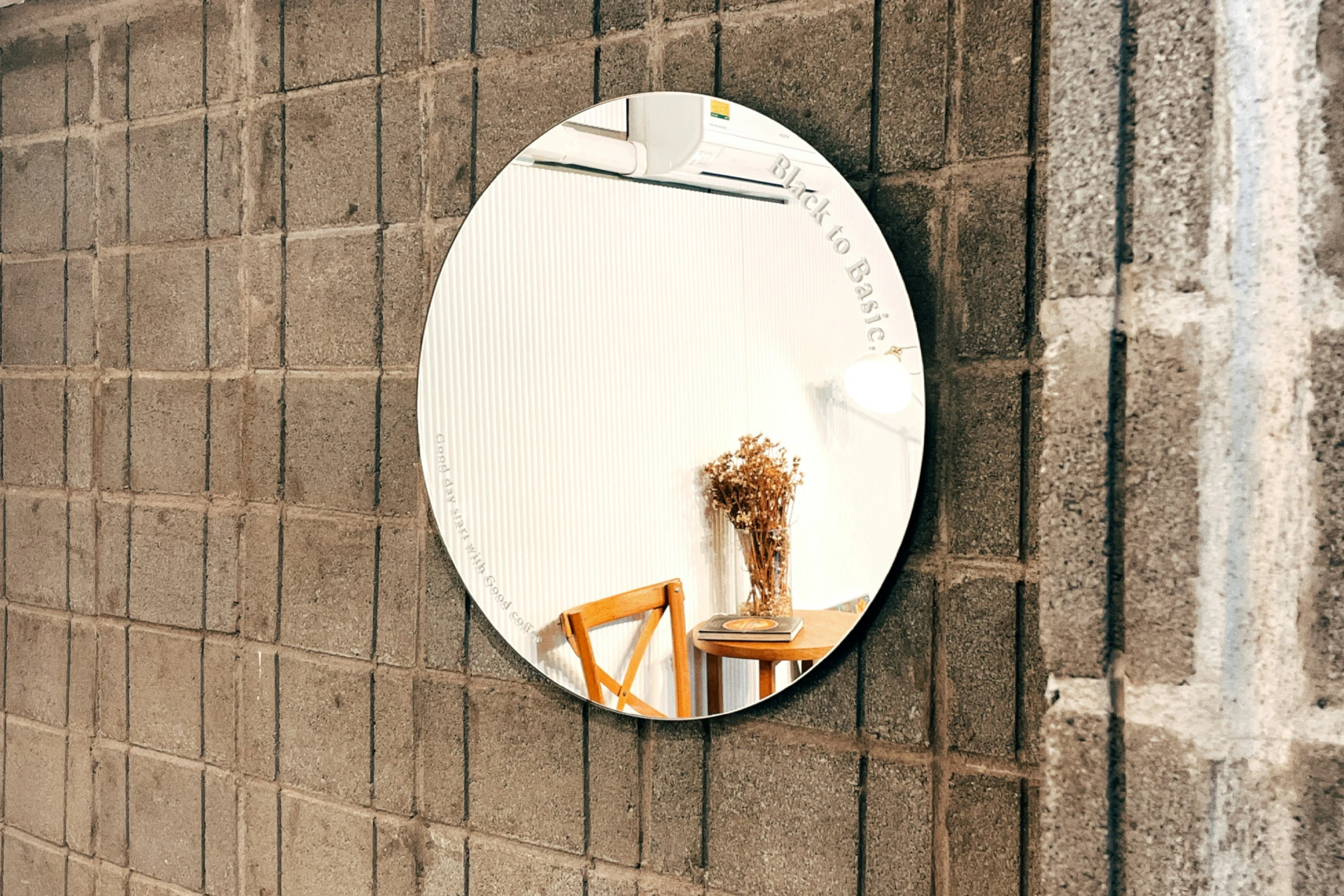 a round mirror that is on the side of a wall