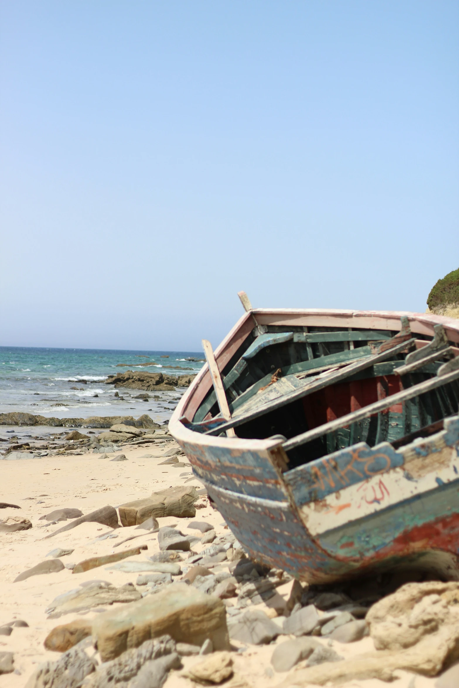 a boat that is sitting on some rocks