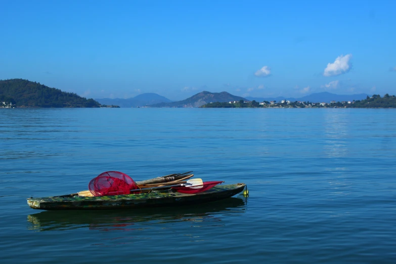 there is a lone kayak on the calm water