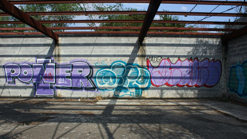 a parking area with graffiti on the wall and ceiling