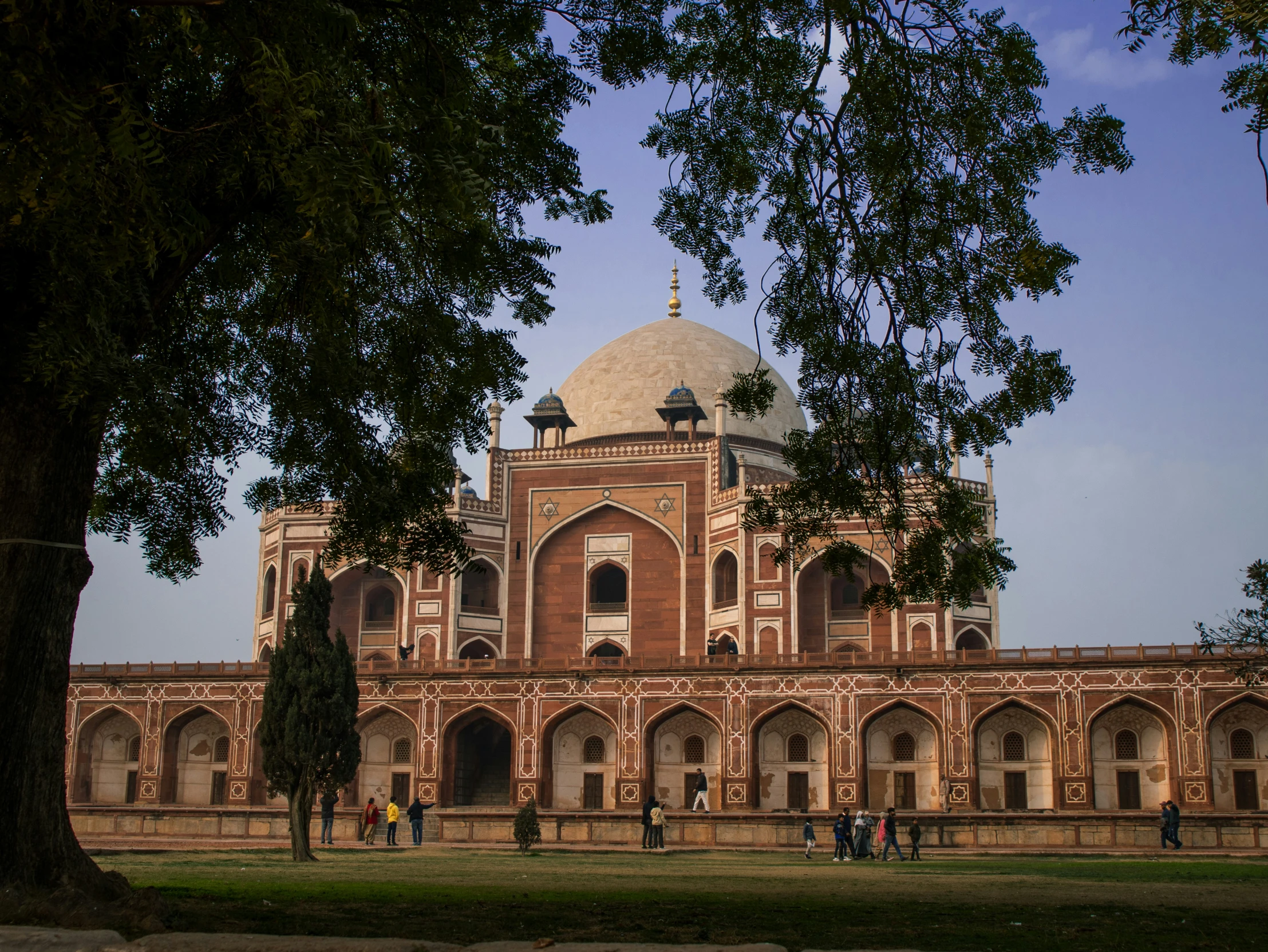 a large brown building surrounded by lots of trees