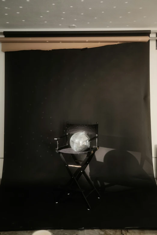 black backdrop behind chair in studio on floor