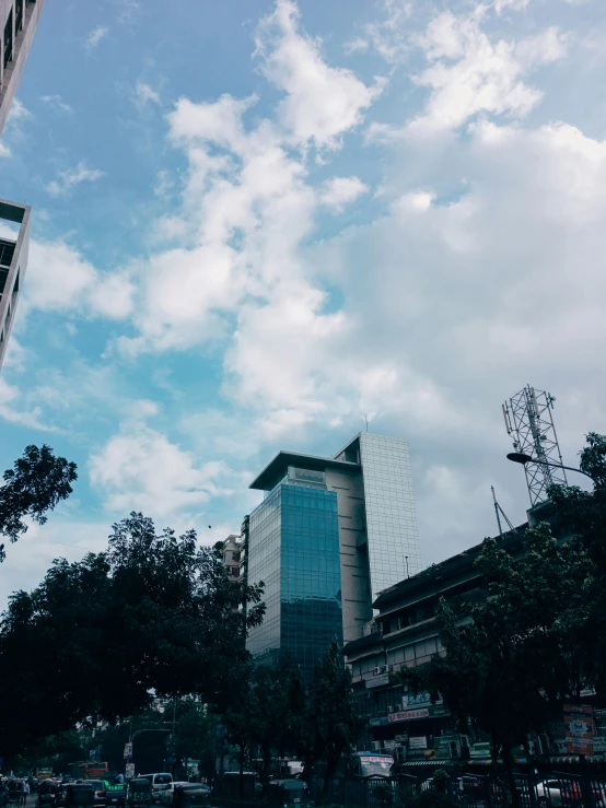 an office building with clouds in the sky