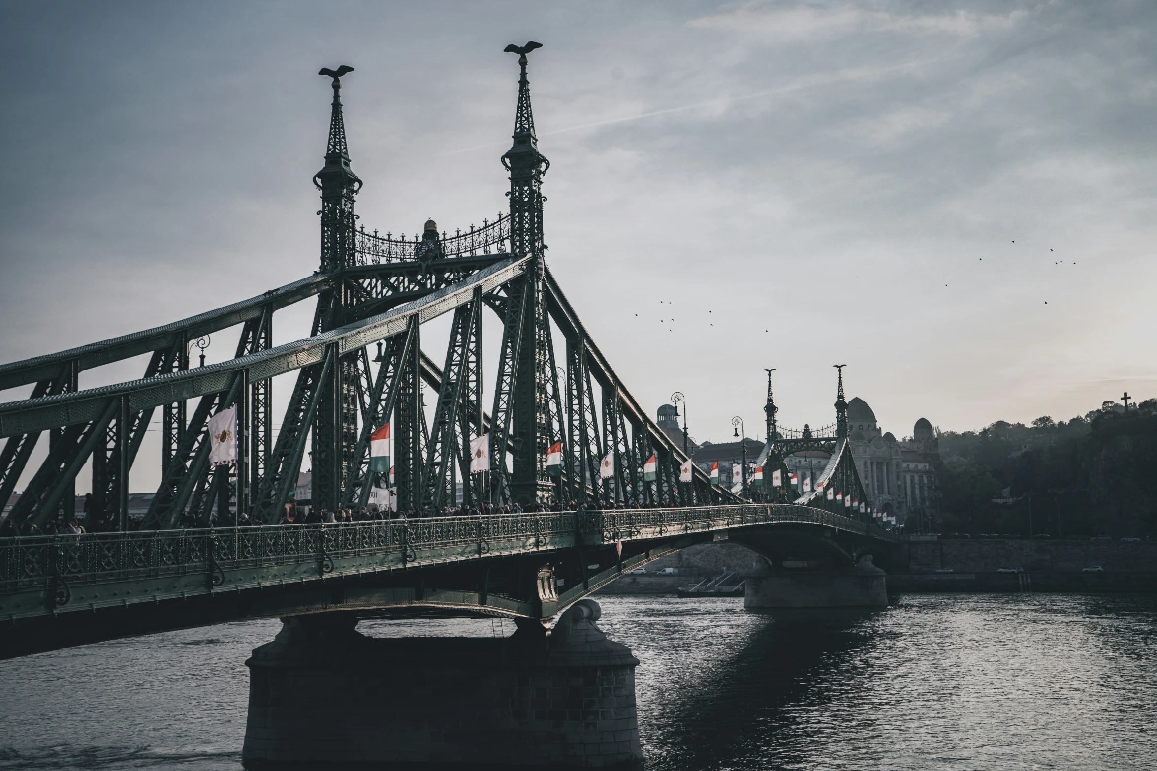 an old suspension bridge going over a river