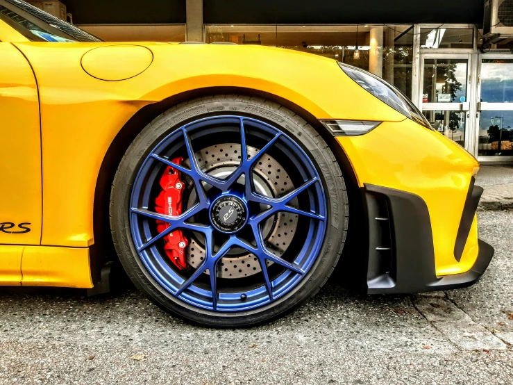 a yellow sports car is parked on the road