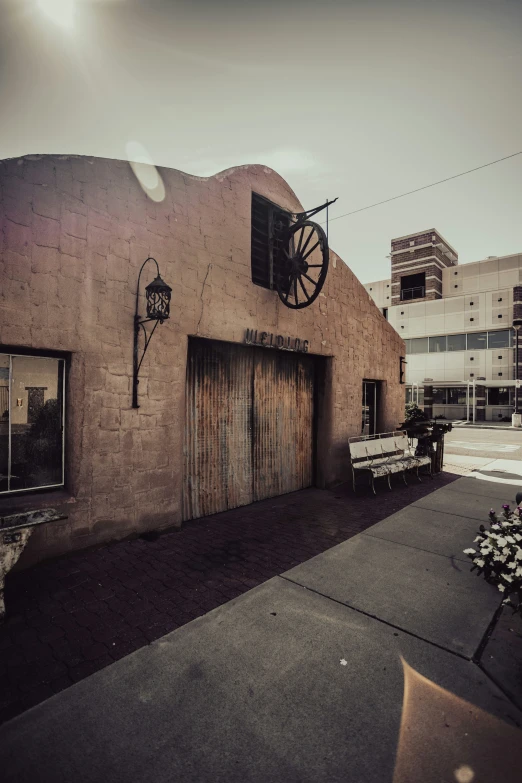 the street view shows two old, industrial buildings and an out door wagon