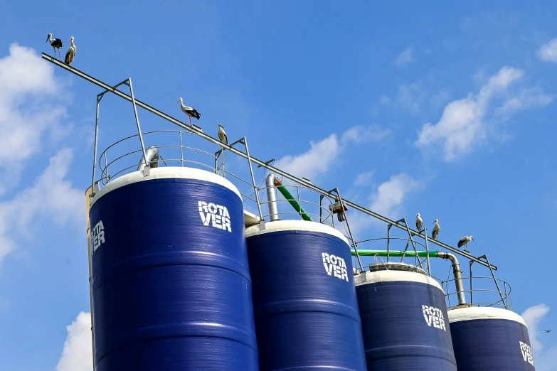 three large blue containers are next to each other