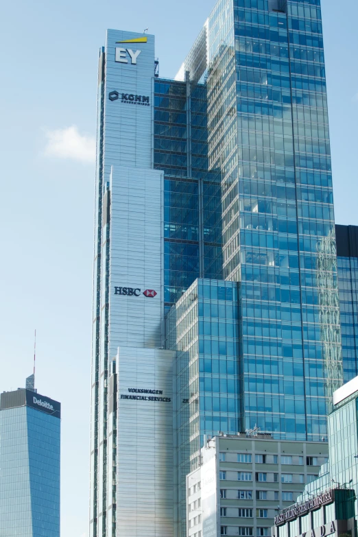 modern skyscrs towering above other high rise buildings