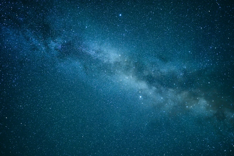 a starr field with a dark sky and stars in the background