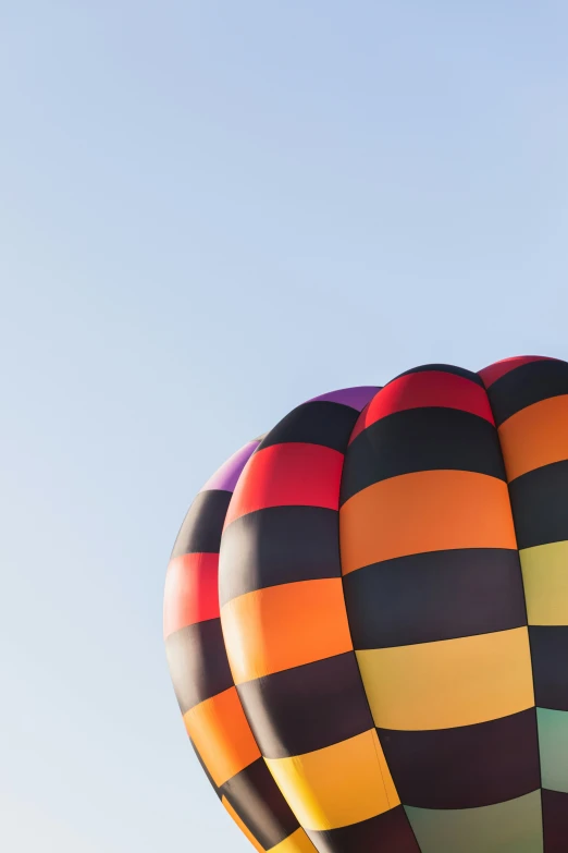 a large air ballon flying through a blue sky