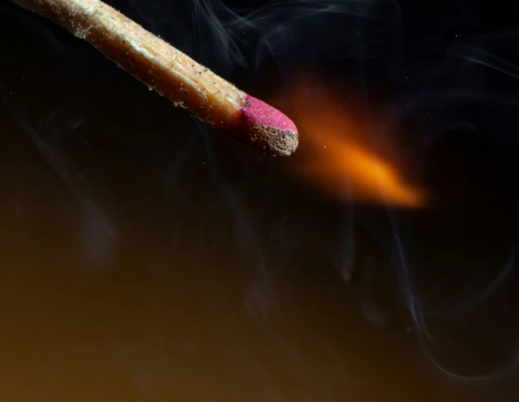 smoke from a match stick is seen on a table