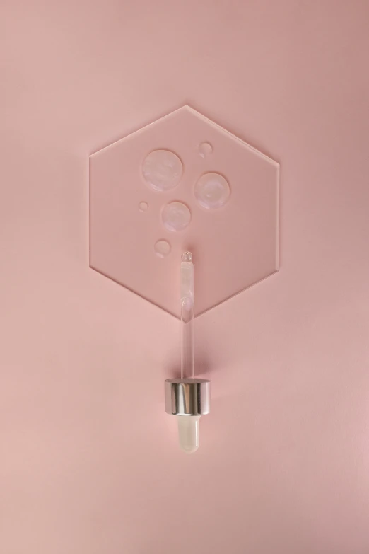 a metal object suspended from a ceiling in a pink room