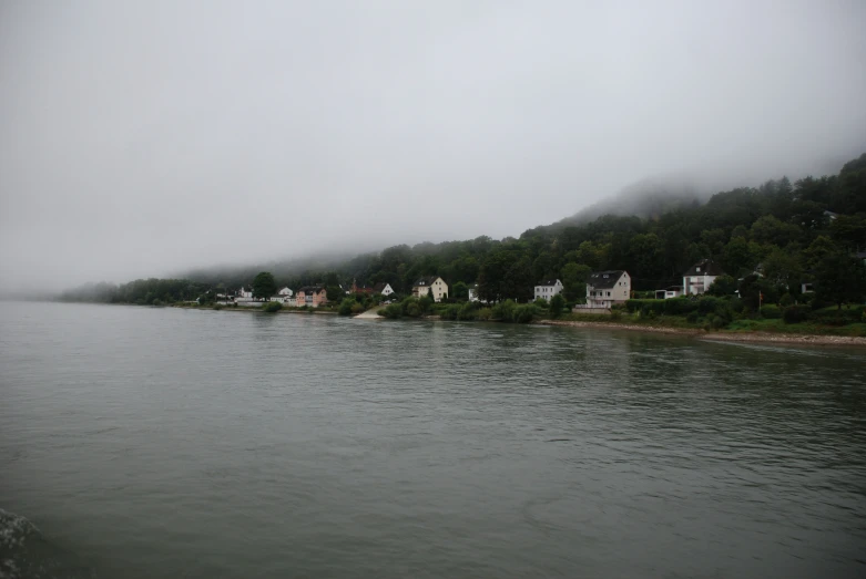 the view of the shoreline has mist hanging over it