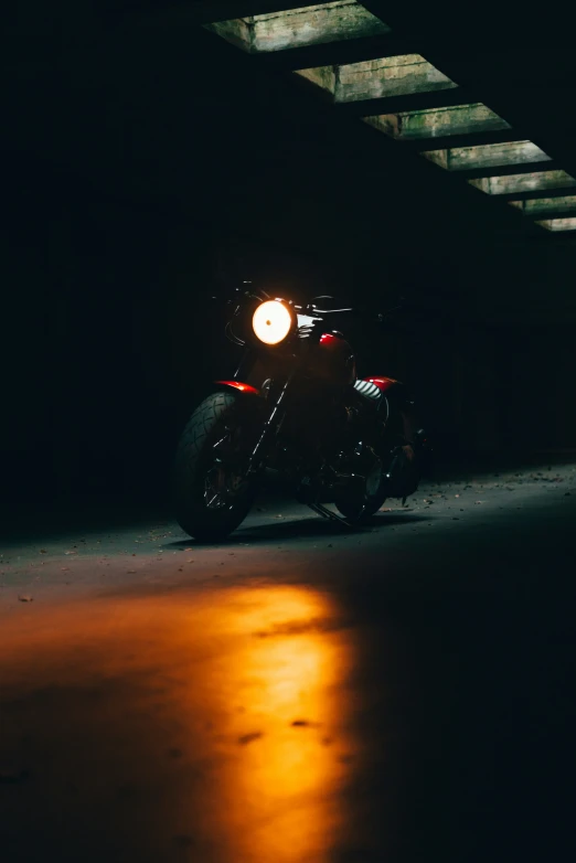 a motorcycle parked under a bridge on the street