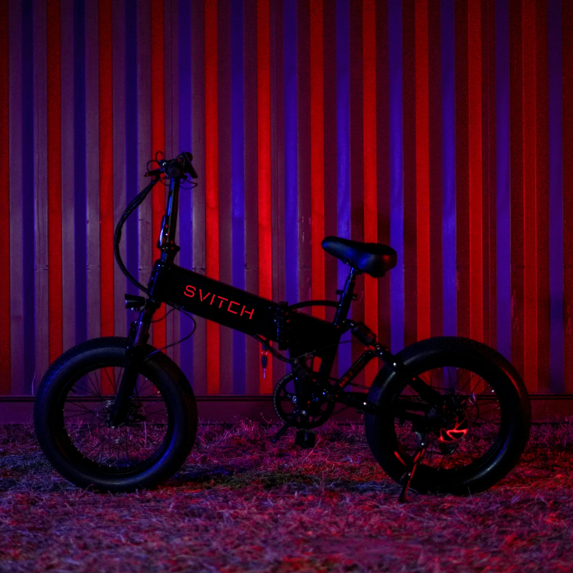 a po of an electric bicycle parked in front of a wall