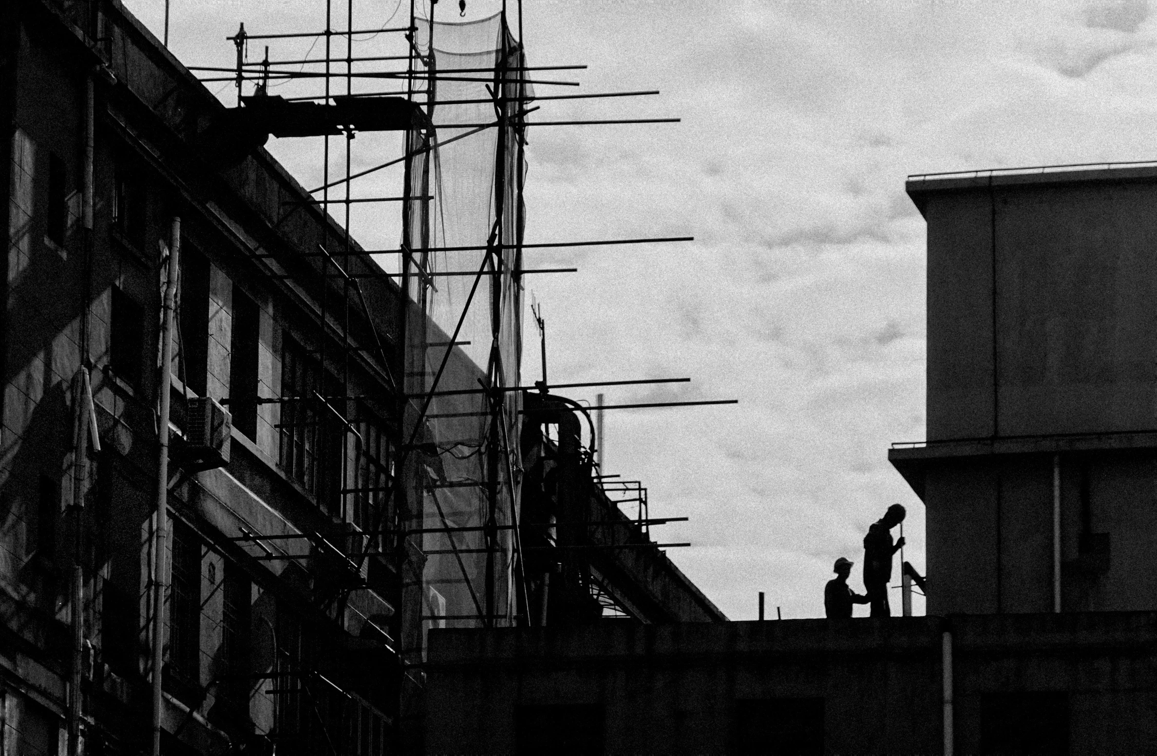 people standing on the top of some kind of building near a clock tower