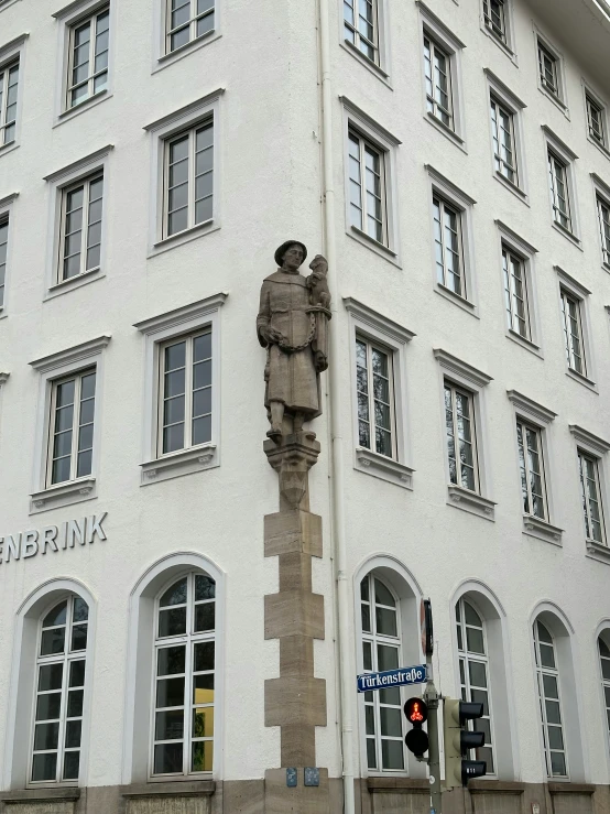 a tall building with a statue on the side of it