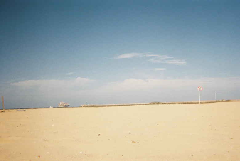 a sandy beach with no grass and only blue sky