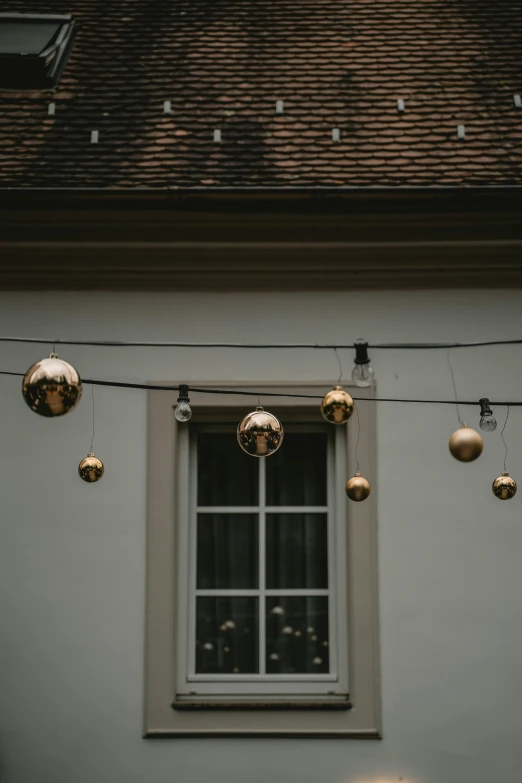 gold - filled ornaments and balls hang from a home