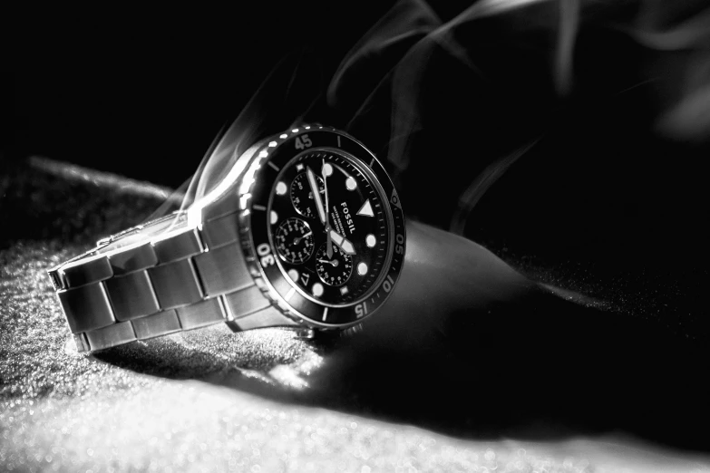 a watch laying on a persons hand, on the ground